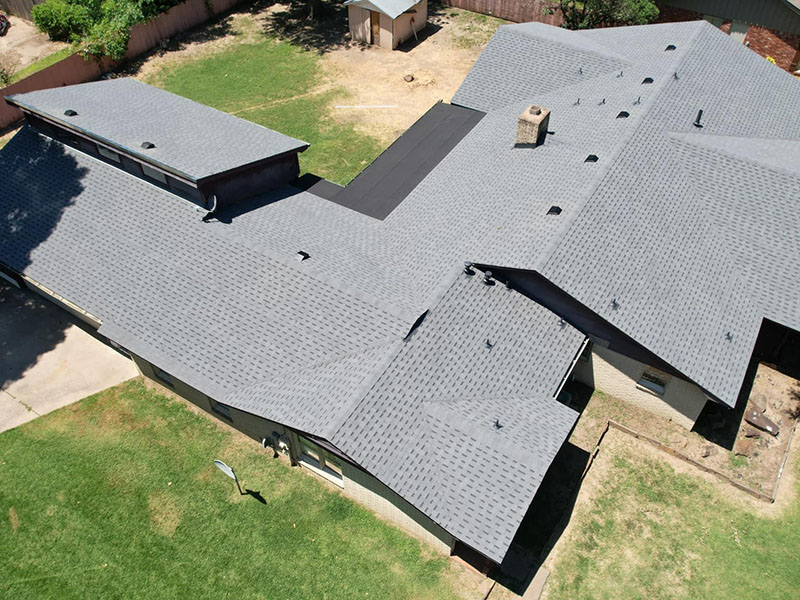 Mid-class residential home that has brand new gray asphalt shingles on it that were installed by MMR Home Solutions LLC